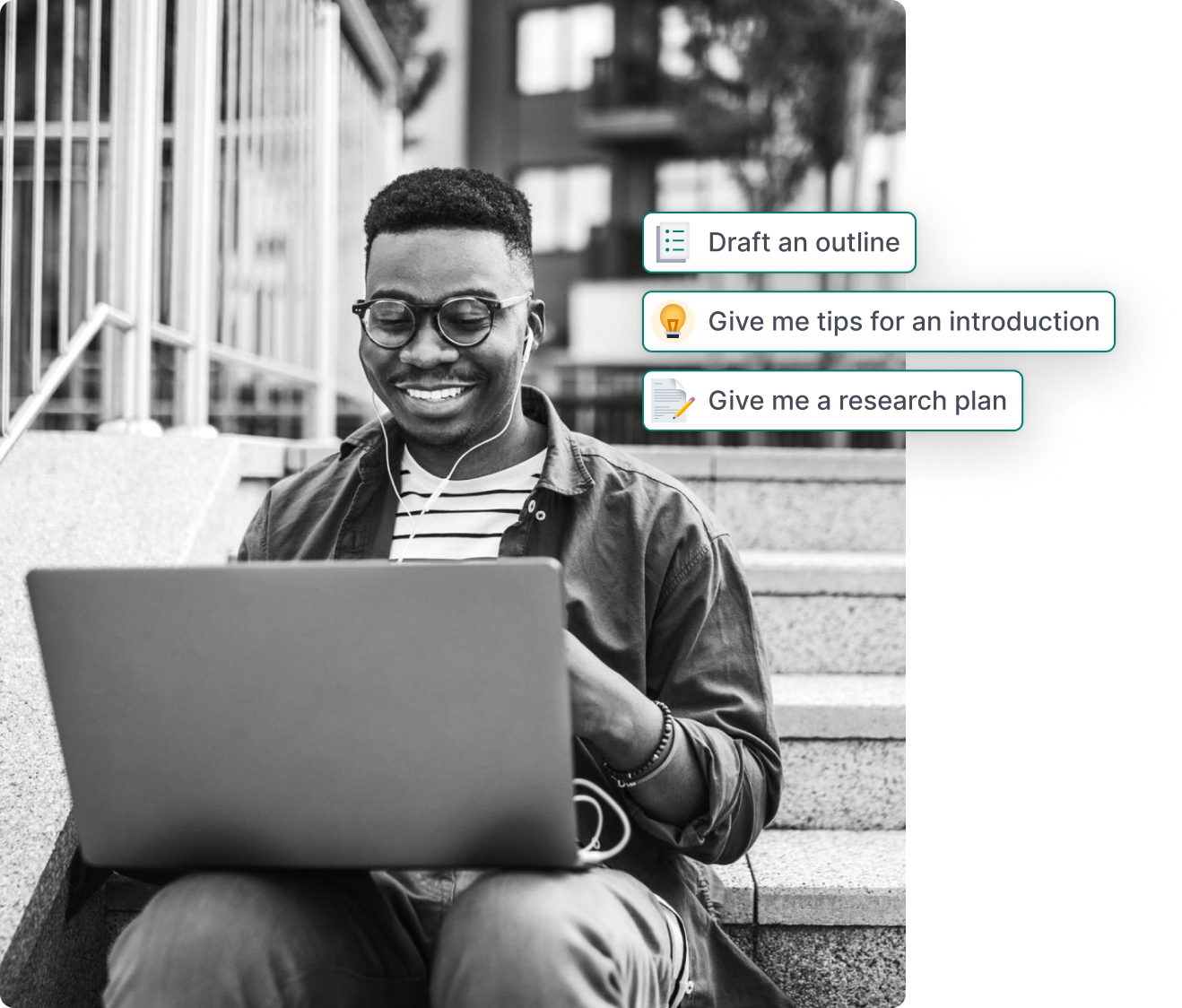 A person sits on a flight of stairs while smiling at a laptop.